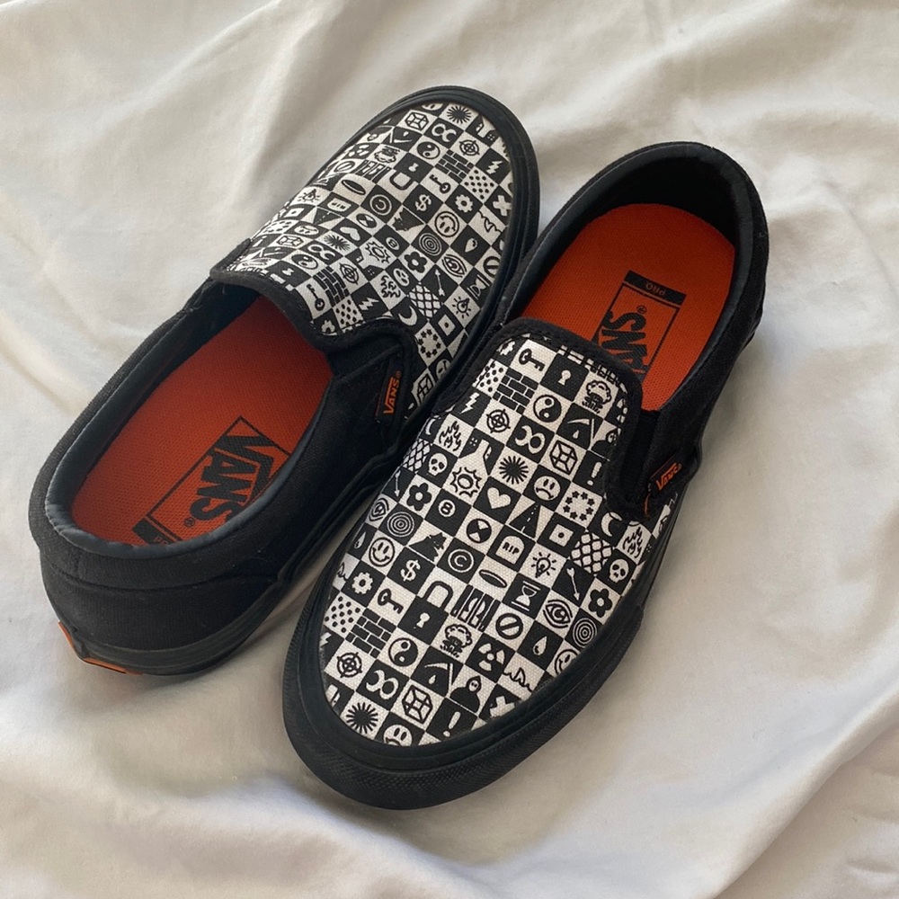 Black, white, and orange slip on Vans. Size 6 mens.